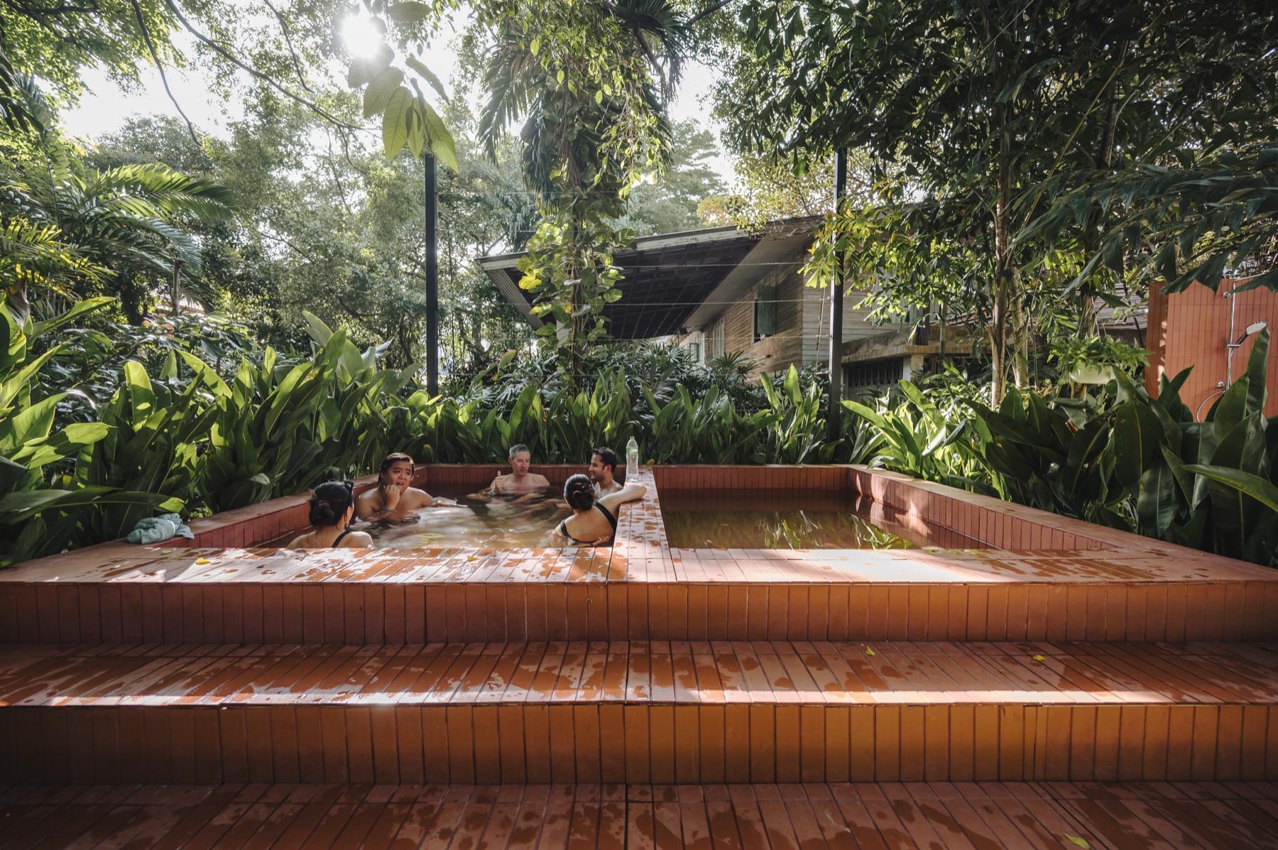 Guests sitting together in Dip Ari’s two garden hot pools